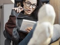 Attractive woman freelancer writer thinking about text and writing in note pad Royalty Free Stock Photo