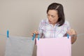 Attractive Woman Hanging Wet Clean Cloth To Dry On Clothes Line