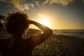 Attractive woman at hawaiian beach watching the sun set