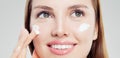 Attractive woman with healthy skin applying cosmetic cream, face closeup. Skincare, beauty and facial treatment concept Royalty Free Stock Photo