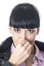 Attractive Woman Holding Her Nose to Stop a Bad Smell or Aroma Royalty Free Stock Photo