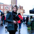 Attractive Woman Holding A Smart Phone Shopping In An Outdoor Market