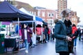 Attractive Woman Holding A Smart Phone Shopping In An Outdoor Market