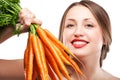 Attractive woman holds bunch of carrots Royalty Free Stock Photo