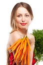 Attractive woman holds bunch of carrots Royalty Free Stock Photo