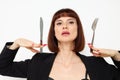 attractive woman knife and fork in hands emotions posing background