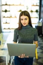 Attractive woman with laptop in modern office look at camera Royalty Free Stock Photo