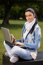 Attractive woman with laptop and sandwitch