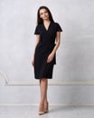 Female model in black wrap around midi dress Royalty Free Stock Photo