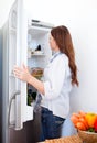 Attractive woman looking into the fridge Royalty Free Stock Photo