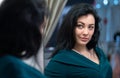 Attractive woman looking at her reflection Royalty Free Stock Photo