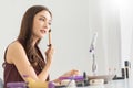 Attractive Woman is looking in the makeup mirror Royalty Free Stock Photo