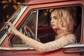 Attractive woman looking at the side mirror retro car Royalty Free Stock Photo