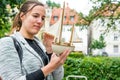 Attractive woman looking at toy model sail boat and dreaming. Royalty Free Stock Photo