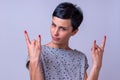 Attractive woman making a devil horns gesture Royalty Free Stock Photo