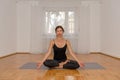 Attractive woman meditating alone in a room Royalty Free Stock Photo