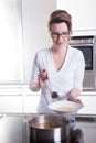 Attractive woman in modern ktchen cooking