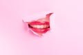 Attractive woman mouth showing a smile thru torn cardboard Royalty Free Stock Photo