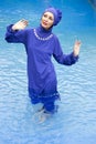Attractive woman in a Muslim swimwear burkini in the pool Royalty Free Stock Photo