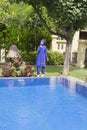 Attractive woman in a Muslim swimwear burkini on a pool side in a tropical garden Royalty Free Stock Photo