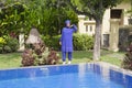 Attractive woman in a Muslim swimwear burkini on a pool side in a tropical garden Royalty Free Stock Photo