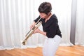 Attractive woman playing the trumpet