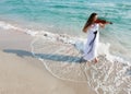 Attractive woman playing violin on beach