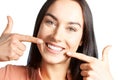 Attractive Woman Pointing To Her Smile With Perfect White Teeth