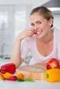 Attractive woman posing while eating vegetables Royalty Free Stock Photo