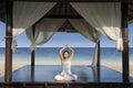 Attractive woman practice yoga at luxury beach resort