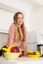 Attractive woman preparing fruit salad in kitchen Royalty Free Stock Photo