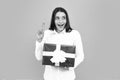 Attractive woman with present box posing with surprised face expression on gray background. Girl holding gift decorated Royalty Free Stock Photo