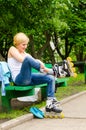 Attractive woman putting on roller blades Royalty Free Stock Photo