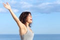 Attractive woman with raised arms shouting to the wind