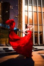 Attractive woman in red fluttered dress. Fire, flame, passion concept. Royalty Free Stock Photo