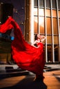 Attractive woman in red fluttered dress. Fire, flame, passion concept. Royalty Free Stock Photo