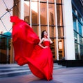 Attractive woman in red fluttered dress. Fire, flame, passion concept. Royalty Free Stock Photo