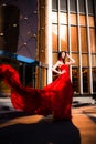 Attractive woman in red fluttered dress. Fire, flame, passion concept. Royalty Free Stock Photo