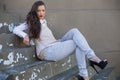 Attractive woman with red lips sitting on stairs posing