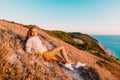 Attractive woman relaxing in nature at warm sunset. Fitness girl in the mountains Royalty Free Stock Photo