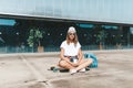 Attractive woman relaxing sitting on the longboard Royalty Free Stock Photo