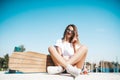 Attractive woman relaxing sitting on the longboard Royalty Free Stock Photo