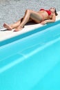 Attractive woman relexing on the swimming pool Royalty Free Stock Photo