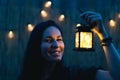 An attractive woman with a retro flashlight at dusk.