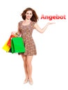 Attractive woman with shopping bags and offering gesture