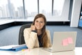 Attractive woman sitting at office chair working at laptop computer desk Royalty Free Stock Photo