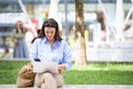 Attractive woman sitting on the park and using mobile phone and laptop for work Royalty Free Stock Photo