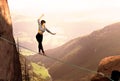 Attractive Woman Slacklining Highlining In The Mountains