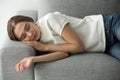 Attractive woman sleeping on comfortable soft sofa