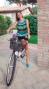 Attractive woman smiles sitting on a bicycle